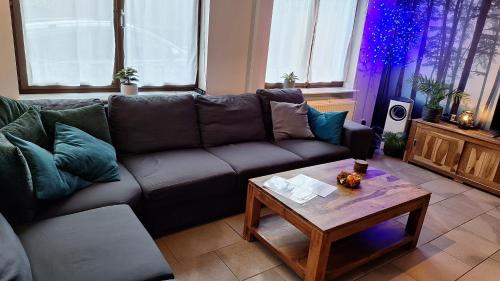 a living room with a couch and a coffee table at WesterOurthe 6 personen Sauna in Durbuy