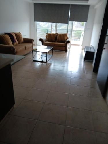 a living room with a couch and a table at 2 bedroom apartment in Nicosia