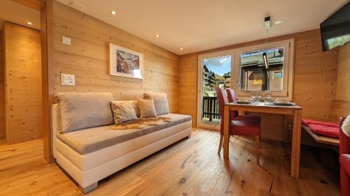 a living room with a couch and a table at Imhof Alpine B&B Apartments in Bettmeralp