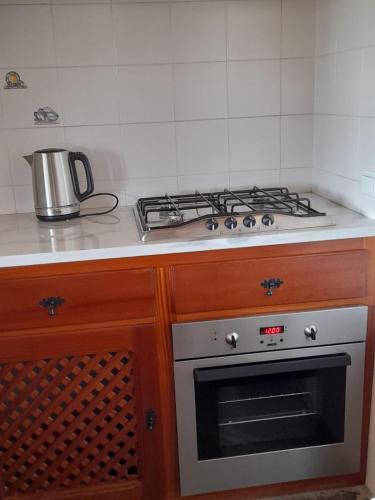 a kitchen with a stove top oven in a kitchen at Monte do Ribeiro Baço - Monsaraz in Monsaraz