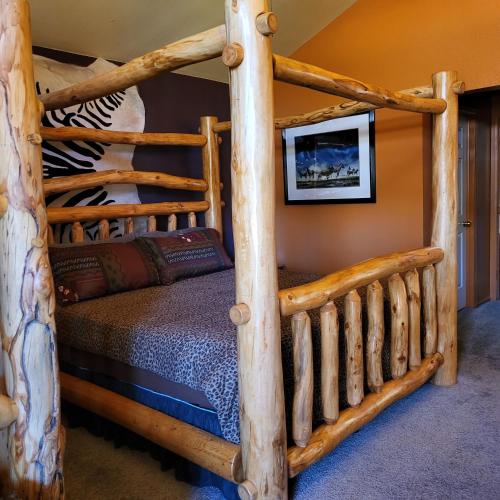 a bedroom with a bunk bed in a log cabin at BuffaloPeaks Lodge in Buena Vista