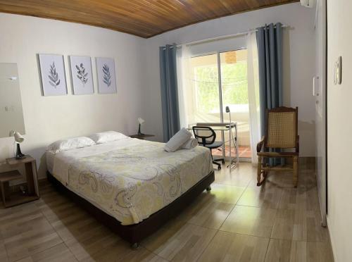 1 dormitorio con cama, mesa y ventana en Céntrico-A pie del mar y del Casco histórico+A/C, en Santa Marta