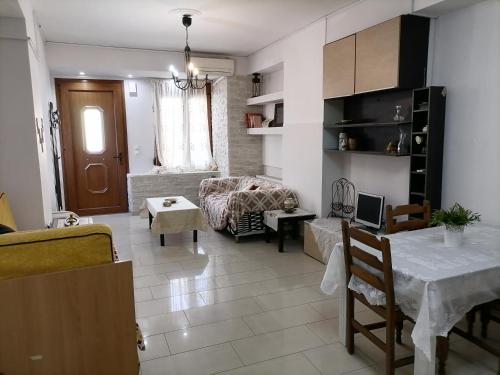 a living room with a table and a couch at PERGAMOS APARTMENTS in Mytilene