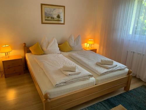 a bedroom with a bed with two tables and two lamps at Apartman BAGI in Kiseljak