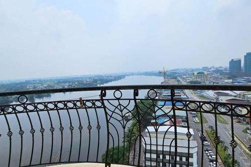 a view of a city from a balcony at Kenyalang Riverine Emerald Condominium Homestay in Kuching