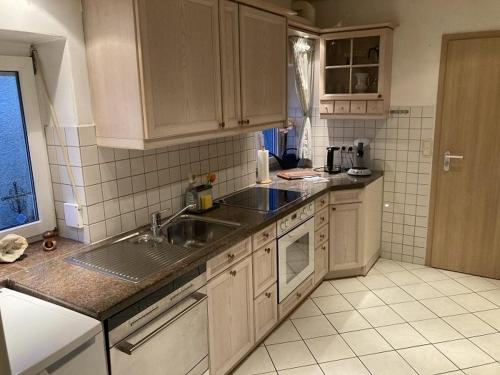 a kitchen with a sink and a counter top at Ferienwohnung historisches Teisendorf in Teisendorf
