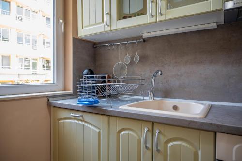 a kitchen counter with a sink and a window at Elegant spotless apartment in Sofia Center in Sofia