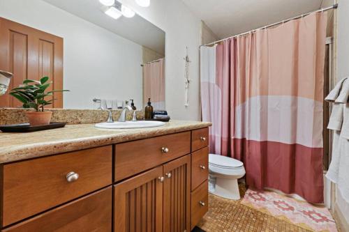 a bathroom with a sink and a toilet at Ocean Beach Pier Condo in San Diego