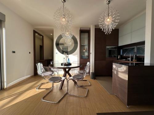 a kitchen and dining room with a table and chairs at Apartment Kovacevic With Sea View in Pržno