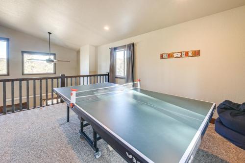 a ping pong table in a room at Spacious Sturgis Cabin with Grill and Wraparound Patio in Sturgis