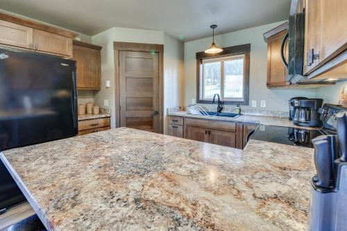 a kitchen with a large marble counter top at Spacious Sturgis Cabin with Grill and Wraparound Patio in Sturgis
