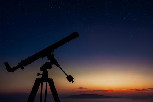 a telescope on a tripod looking at the stars at [cala piccola] magical sunset + reserved beach in Monte Argentario