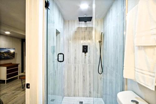 a bathroom with a shower with a glass door at Private Studio Oasis I Groceries & Eats Nearby in Oklahoma City