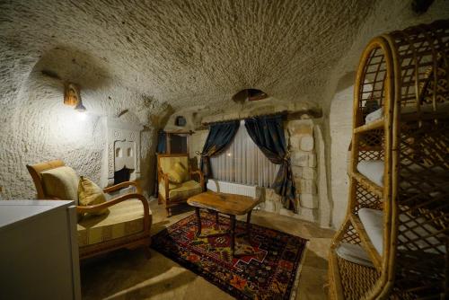 a room with bunk beds and a couch and a chair at Cappadocia Nar Cave House & Swimming Pool in Nevsehir