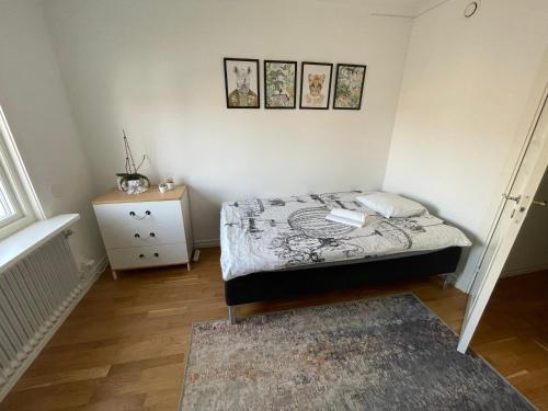 a small bedroom with a bed and a night stand at Villa Rydholm 15 minutes from Gothenburg Center in Gothenburg