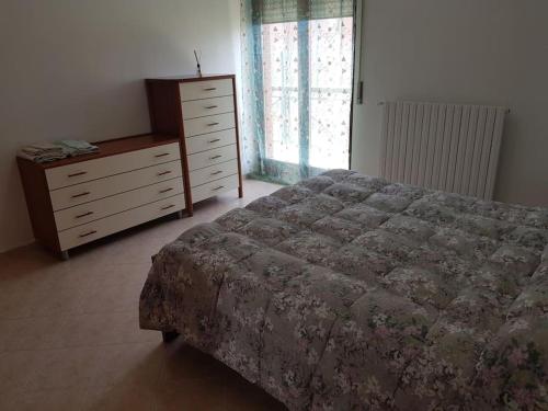 a bedroom with a bed and a dresser and a window at Residence Artemide 5° in Isernia