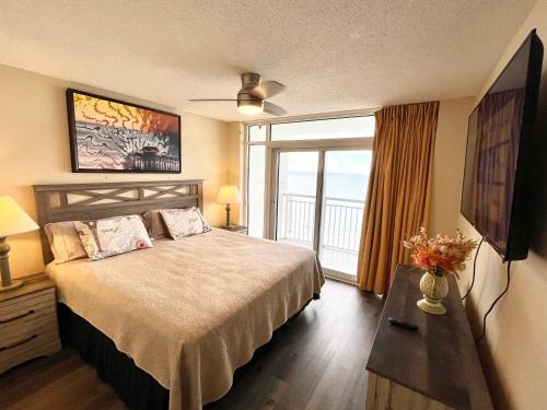 a hotel room with a bed and a large window at Atlantica Resort in Myrtle Beach