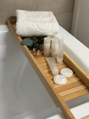 a tray with towels and spa items on a bed at Boutique Apartment in Bucharest