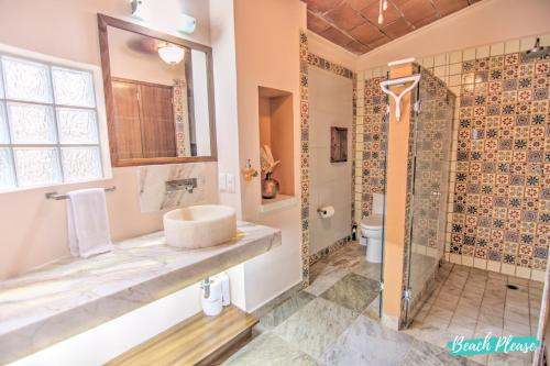 a bathroom with a sink and a shower at Casa Colibri - Private Beachfront Oasis in Cruz de Huanacaxtle