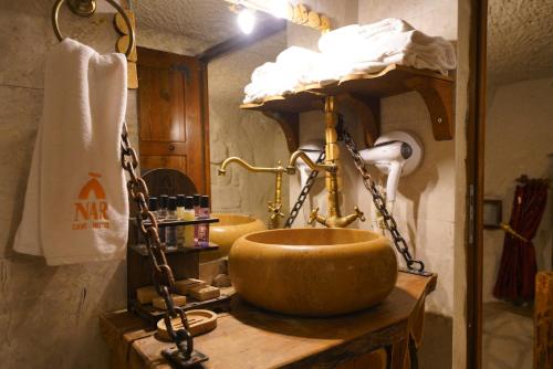 a bathroom with a large bowl sink on a table at Cappadocia Nar Cave House & Swimming Pool in Nevsehir