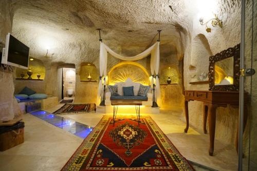 a bedroom with a bed in a stone room at Cappadocia Nar Cave House & Swimming Pool in Nevsehir