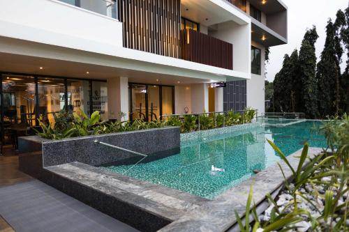 a swimming pool in front of a house at Chic Retreat - 1-Bedroom Haven in Accra