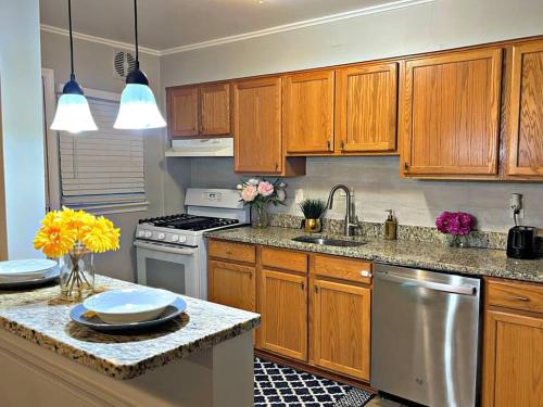 a kitchen with wooden cabinets and a counter top at Towson Center BNB in Towson