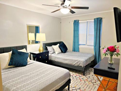 a bedroom with two beds and a ceiling fan at Towson Center BNB in Towson