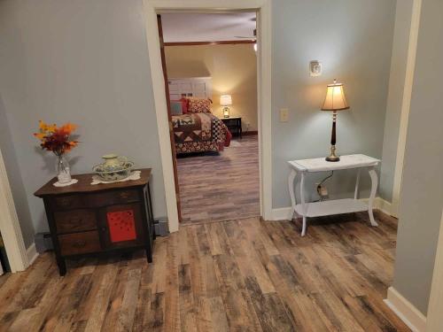 a hallway with a room with a bed and a table at Moonlight Manor Bed & Breakfast in Floyd