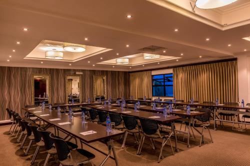 a large room with a long table and chairs at Protea Hotel by Marriott Lagos Kuramo Waters in Lagos