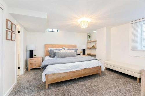 een witte slaapkamer met een groot bed en een bank bij Freshly Updated 5BR/2.5B 5min to ND Stadium in South Bend