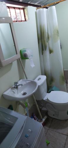 a bathroom with a toilet and a sink at Casa Vacacional Los Guayacanes in Baños