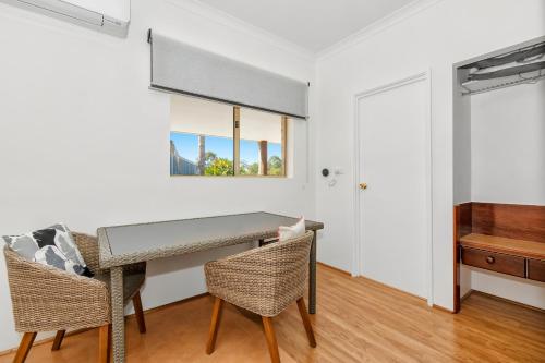 a dining room with a table and two chairs at 101 Oatlands in Mount Barker