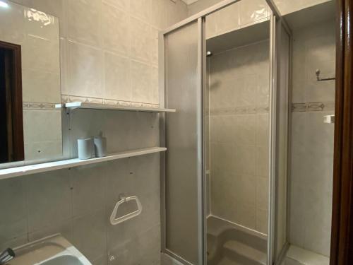 a bathroom with a shower and a sink and a mirror at Cozy Holiday Home in Serroventoso near coast 