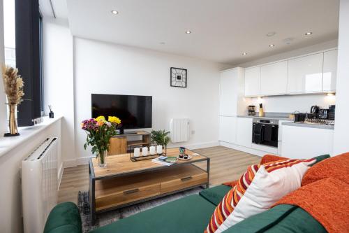 a living room with a couch and a coffee table at Chic Luxury Apartment near Old Trafford Stadiums Manchester in Manchester