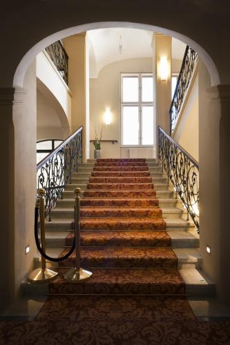 a staircase in a building with a large window at Grandhotel Ambassador Národní Dům in Karlovy Vary