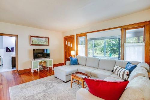 a living room with a white couch and a tv at Artist’s Vintage Home 5 mins from ND Campus in South Bend