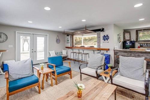 a living room with blue chairs and a bar at Cozy Home w/ Sonos + Walking to Notre Dame in South Bend