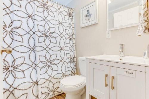 a bathroom with a toilet and a shower curtain at Cozy Home w/ Sonos + Walking to Notre Dame in South Bend