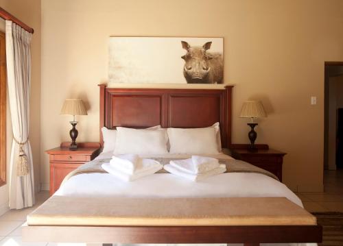 a bedroom with a bed with two pillows on it at Whispering Waters in Fort Nottingham