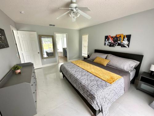 a bedroom with a bed and a ceiling fan at After thrill come and chill in Davenport