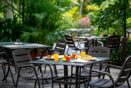 a table and chairs with food on top at Sunshine Resort Intime Sanya in Sanya