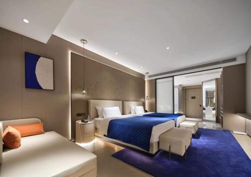 una camera d'albergo con letto e divano di Vance Hotel - East Railway Station a Hangzhou