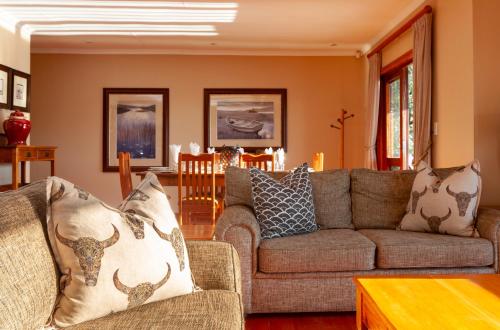 a living room with a couch and a table at Whispering Waters in Fort Nottingham