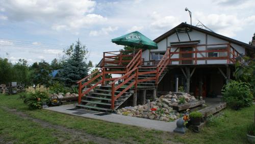 a house with a staircase leading up to it at Agroturystyka Makowscy in Trzcianka