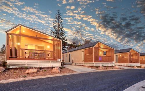 a row of modular homes on the side of a road at Reflections Bermagui - Holiday Park in Bermagui