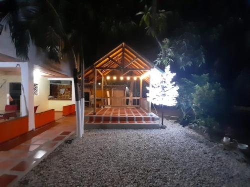 a house with a lit up porch at night at Ukiyo Cabin in Santa Marta