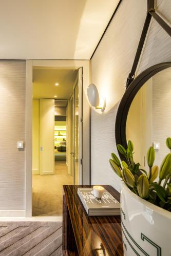 a living room with a table and a mirror at Cidnay Santo Tirso - Charming Hotel & Executive Center in Santo Tirso