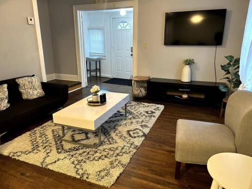 a living room with a couch and a coffee table at A Lovely Retreat in St Paul in Saint Paul