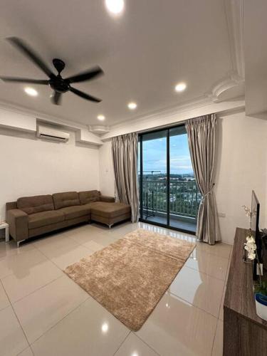 a living room with a couch and a large window at Minimalist City View Home with 3BR at Meru Ipoh in Bandar Meru Raya